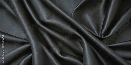 Luxurious Black Silk or Satin Texture Background with Smooth Flowing Folds, Elegant Waves, Soft Highlights, and Abstract Curved Textile Design