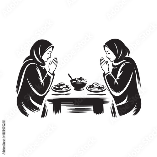 Two women in hijab praying with a meal of food before them