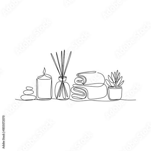A serene spa scene featuring candles rolled towels and a small succulent plant