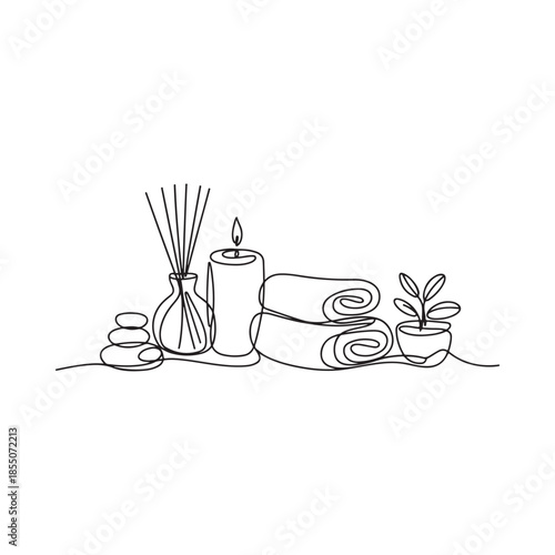 Minimalist spa arrangement with stones candle rolled towels and plant