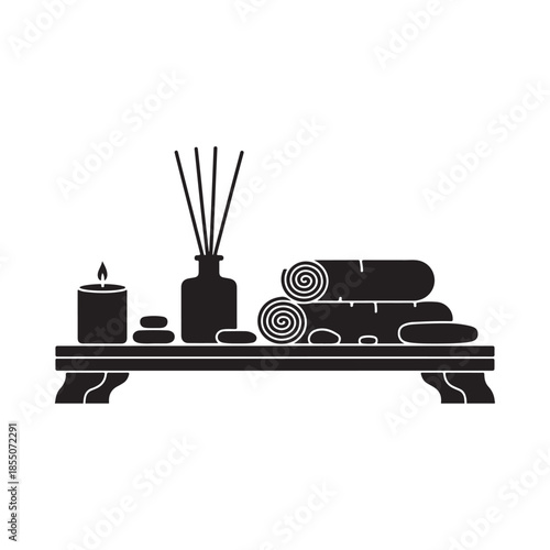 A serene spa arrangement featuring candles diffusers and rolled towels