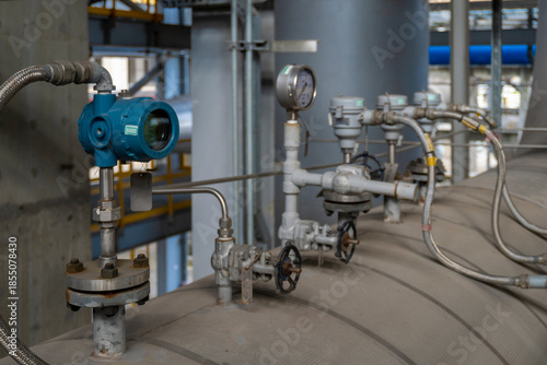Group of valves and gauges are on a pipe. The gauges are showing the pressure of the pipe
