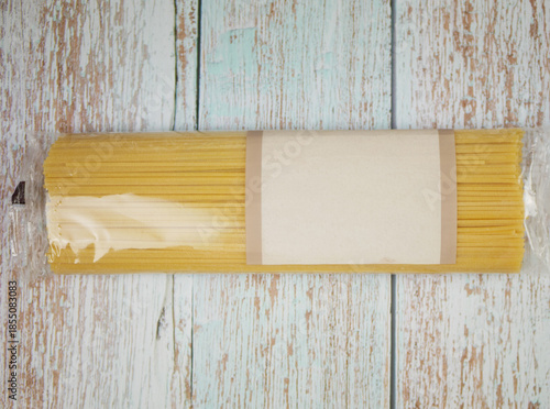 Wallpaper Mural Packaged spaghetti bundle placed on distressed wooden surface showing pasta shape, clean product layout, and ingredient clarity for culinary themes, branding visuals, and modern food design, pro photo Torontodigital.ca