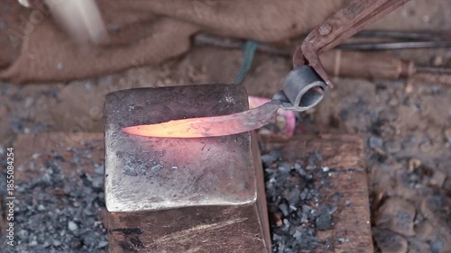 Farming iron tools heat over glowing embers in a small Uttarakhand village blacksmith shop, showing rural livelihood, poverty, manual labor, and traditional mountain craftsmanship.