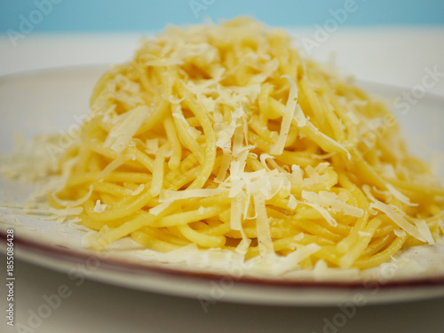 Wallpaper Mural Closeup view of cooked spaghetti covered with grated parmesan cheese on a white plate, warm cheesy pasta portion for Italian comfort food and restaurant menu visuals Torontodigital.ca