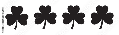 Four black shamrock leaves are arranged horizontally in a simple graphic illustration, symbolizing luck, Ireland, and St. Patrick's Day celebrations.