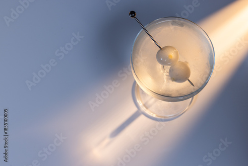 Wallpaper Mural Gibson martini on a reflective white surface with high contrast lighting and contrasting tones. Torontodigital.ca