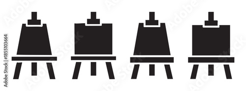 Four black art easels with blank canvases standing upright, representing creativity, artistic expression, and the process of painting or display.