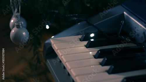 Piano organ with Christmas baubles and twinkle lights