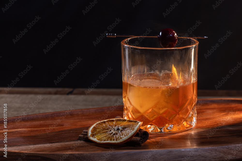 custom made wallpaper toronto digitalwhiskey cocktail served on the rocks garnished with a dehydrated orange slice and a cherry with dramatic lighting served on a wooden surface.