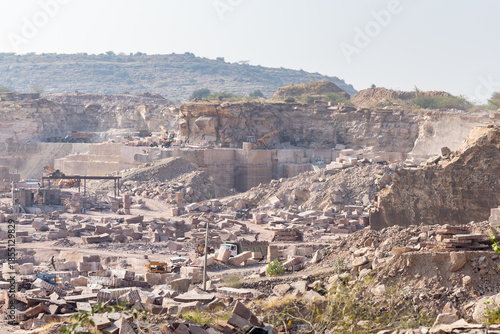 industrial stone mining area with exposed granite formations in Aravalli range