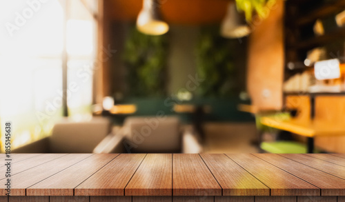 Empty wooden table top with lights bokeh on blur restaurant background.