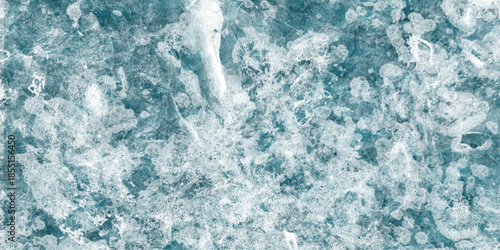 Aerial view of turbulent ocean waves and white foam, capturing the power and movement of the sea in vivid blue tones. Retro rough limestone grunge wall aged blue marble.
