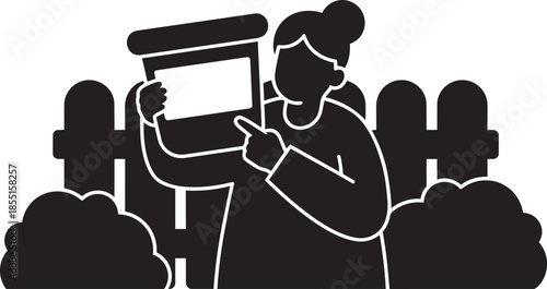 Woman holding and pointing at plant pot in garden scene with fence and bushes