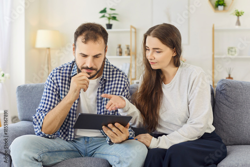 Canvas Print Couple with tablet browsing internet at home