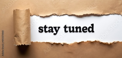 Torn paper reveals black letters spelling stay tuned on white background. Message suggests waiting for updates, news, or upcoming events. Crafty look for announcements.