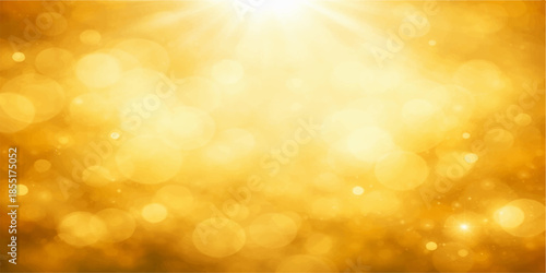 Shiny golden Christmas background with soft blurred bokeh lights and a festive glitter glow in a bright yellow and orange defocused pattern