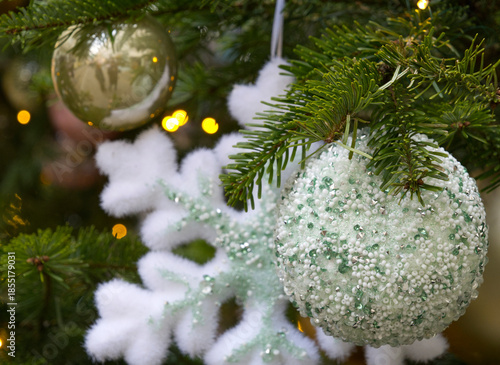 New Year's Eve decoration of street. Christmas trees with balls on branches.