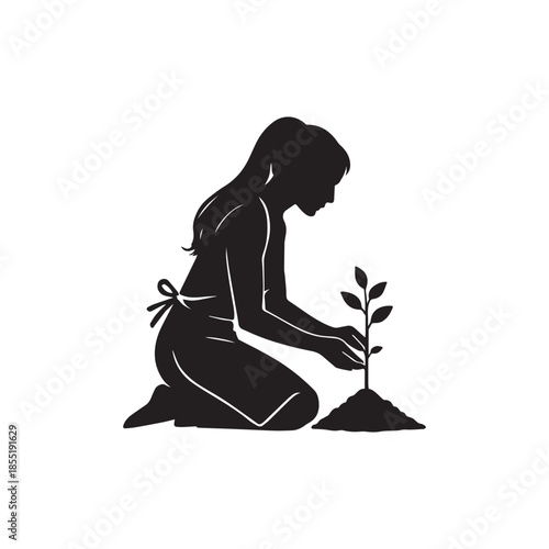 Silhouette of a woman wearing an apron kneeling and carefully planting a small seedling in the soil outdoors