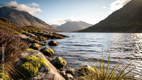 Serene Mountain Lake Landscape with Rocky Shoreline and Clear Blue Sky.