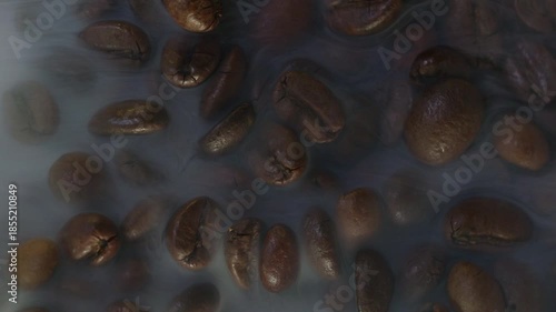 Roasted Coffee Beans With Swirling White Smoke on Black Background Copy Space 