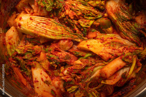 Close-up view of Korean kimchi showing fermented cabbage with red pepper seasoning, representing Korean cuisine, healthy fermented foods and attractive table presentation.