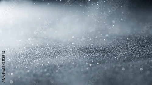 Glittering gray dust particles floating on abstract atmospheric texture