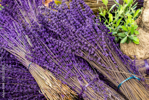 Dried purple lavender flower bunches for aromatherapy and rustic decoration background
Caption