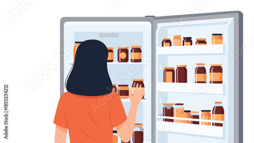 Woman seen from behind, looking intently into an open refrigerator meticulously organized with numerous jars of preserves and condiments.