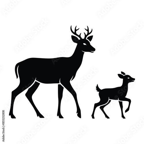 Silhouette of a majestic stag with antlers walking alongside a playful fawn