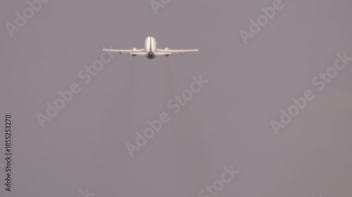 Rear perspective of an airliner with unbranded livery climbing after departure, symbolizing air travel and global journeys