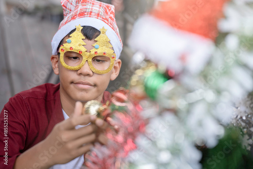 The children are celebrating Christmas and decorating the Christmas tree together.