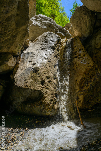 Waterfall cascading through a rocky canyon