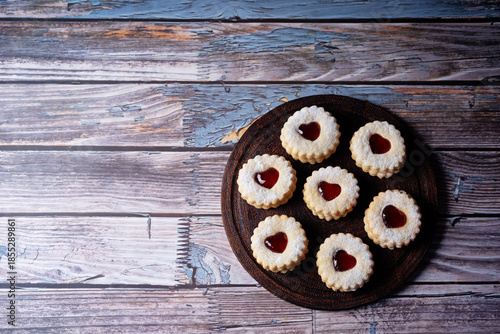 Linzer cookies with strawberry jam and heart shape topping for Valentine's day holiday