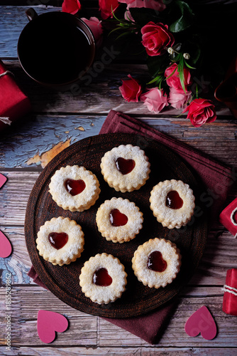 Linzer cookies with strawberry jam and heart shape topping for Valentine's day holiday