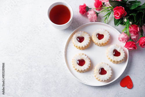 Linzer cookies with strawberry jam and heart shape topping for Valentine's day holiday