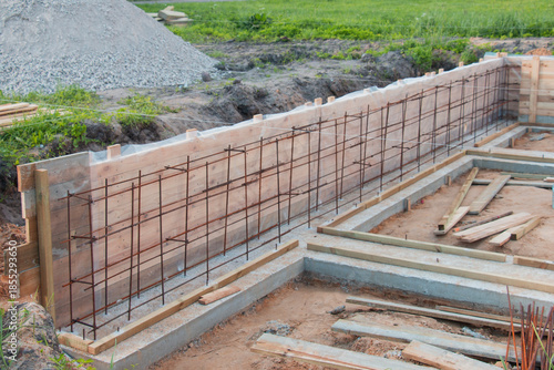 Construction of a new concrete foundation for a residential building at a construction site.