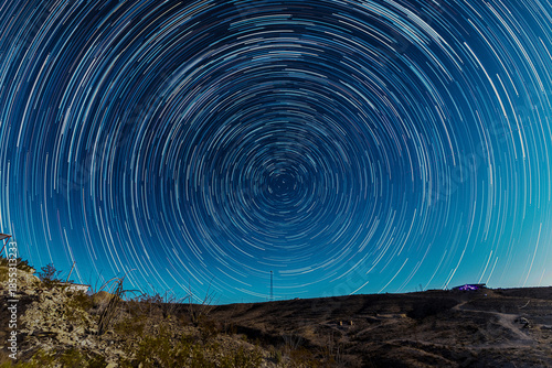 Circular star trails spin over the desert night in Terlingua.