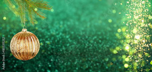 Fényképezés Christmas ball hanging from fir tree branch against festive background with bokeh lights