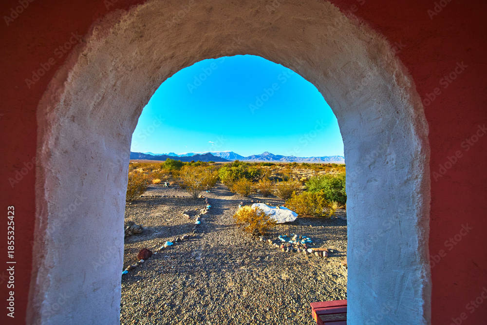 Fototapeta premium Temple Archway Framing Nevada Desert Path and Distant Mountains at Golden Hour