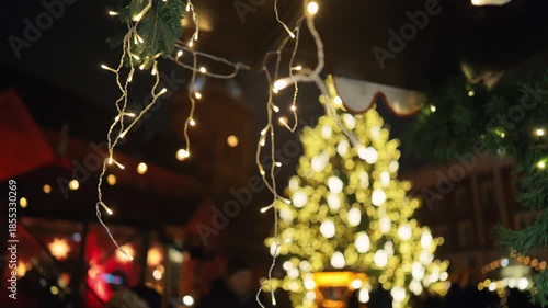 Closeup of sparkling decorative lights creates warm festive ambiance for celebration scenes slow motion