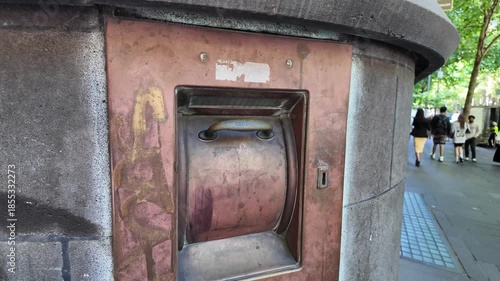 An obsolete bank night safe embedded in the exterior wall of a historic banking building in Melbourne, Australia, with a heavy metal deposit door.
