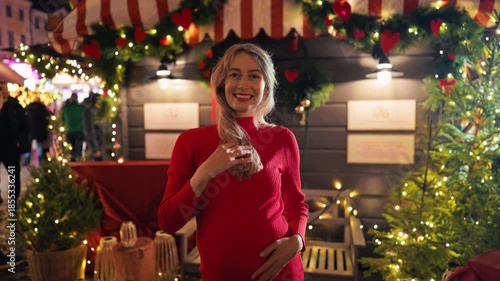 Elegant maternity fashion imagery, Chic pregnant woman in vibrant dress with holiday lighting ambiance slow motion