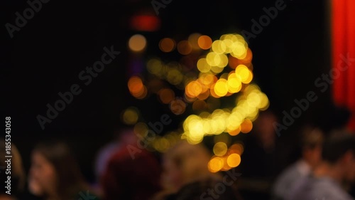 Fuzzy festive scene, Blurry audience observing colorful holiday illumination with warm ambiance slow motion