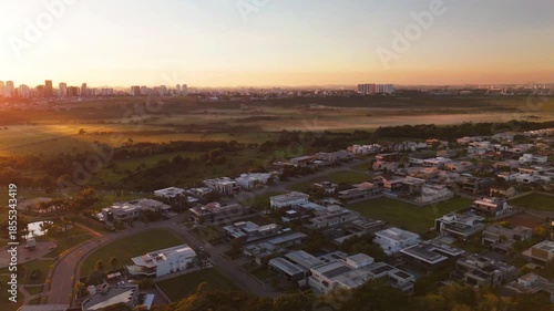 aerial view of a sunrise in Sao Jose dos Campos city with beautiful blue and orange sky in the countryside of Brazil. Astonishing landscape and the city scape in the distance.