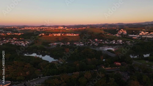 aerial view of a sunrise in Sao Jose dos Campos city with beautiful blue and orange sky in the countryside of Brazil. Astonishing landscape and the city scape in the distance.
