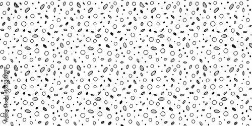 An abstract black and white pattern of repeating oval shapes