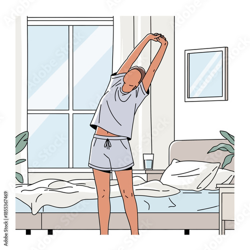 Woman stretching in pajamas by the bed in a bright bedroom, morning routine