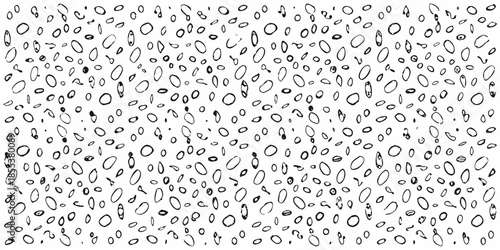 A dense pattern of abstract hand drawn oval and circular shapes in black and white
