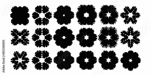 Arrangement of intricate dark floral patterns resembling snowflakes or botanical designs
